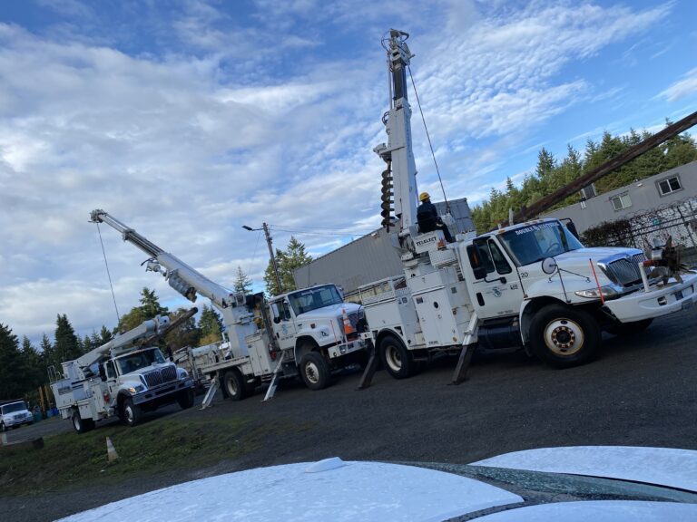 Pole Trucks Installing Utility Pole at OlyCap in Port Townsend, WA